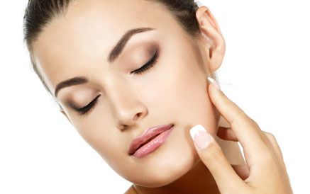 woman touching her cheek